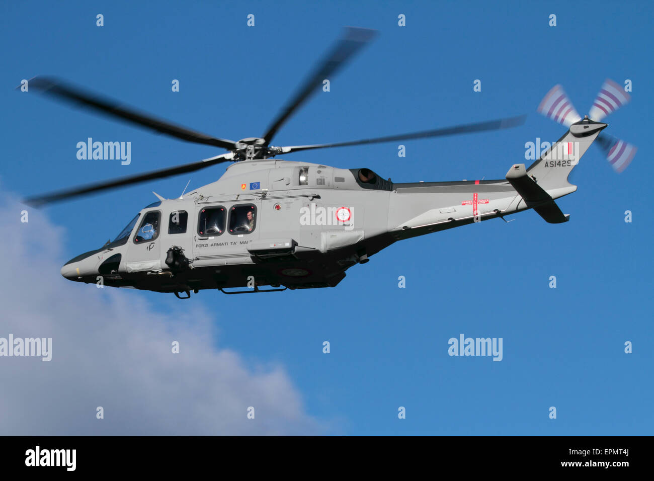 AgustaWestland (Leonardo) AW139 maritime patrol / search and rescue helicopter of the Armed Forces of Malta flying in the sky with wheels up Stock Photo