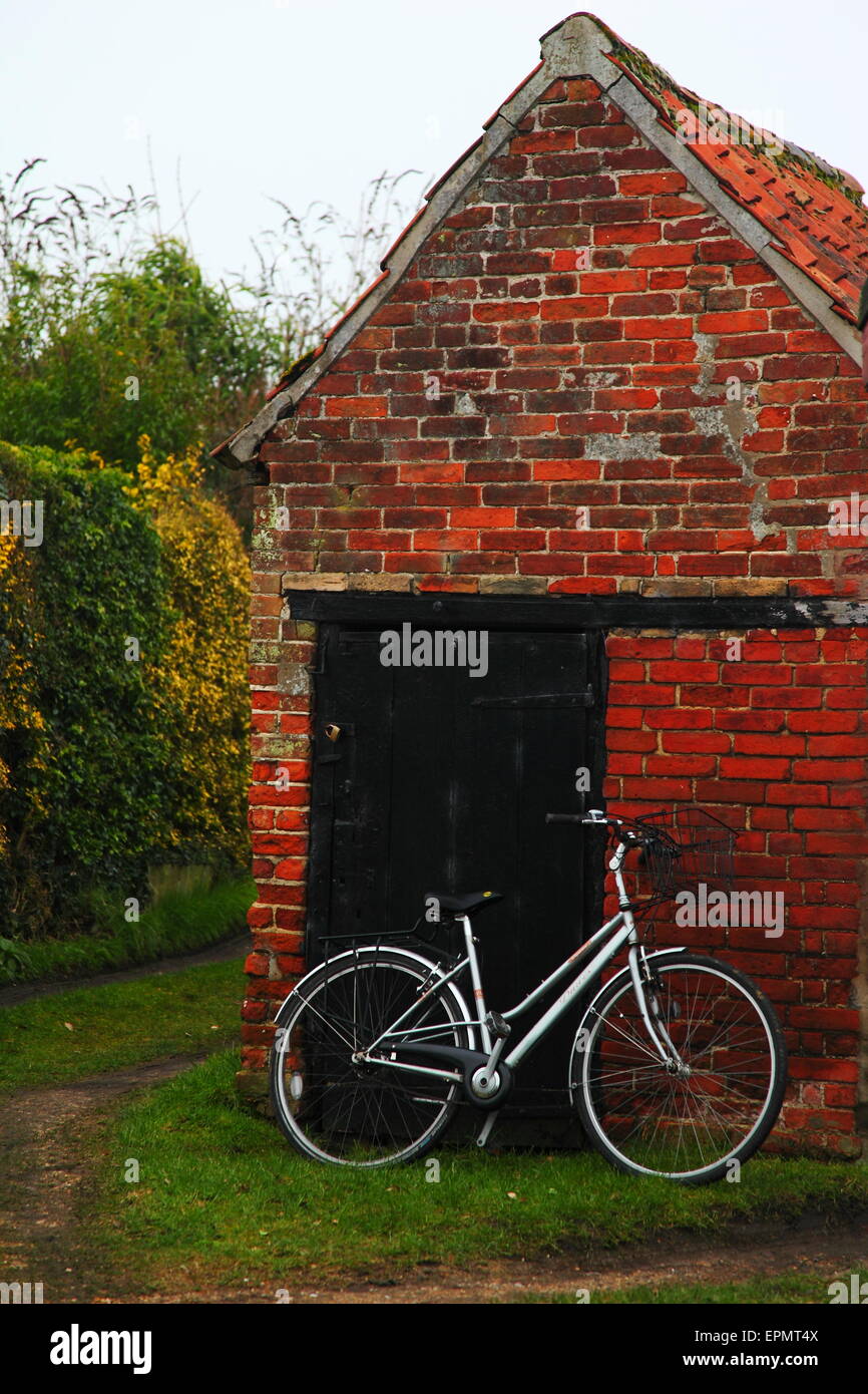 Bicycle leaning on old brick outhouse at Westleton Village Suffolk, east, anglian, daily, times, Stock Photo