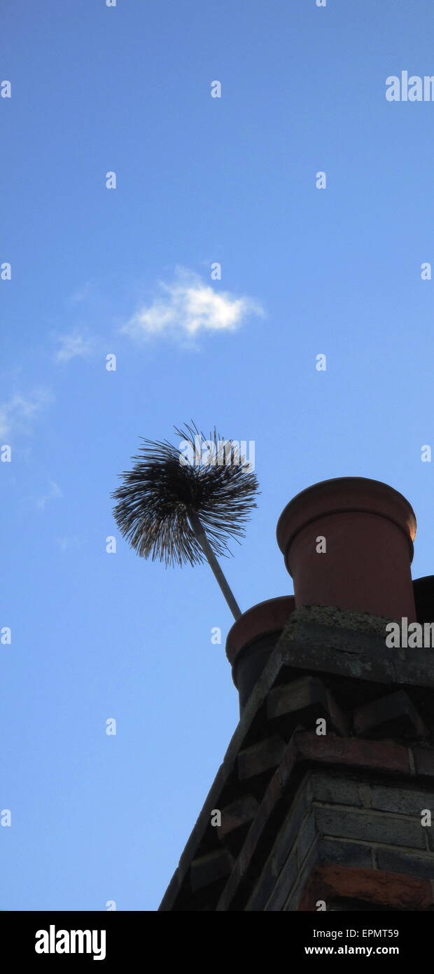 Chimney sweep brush poking out of chimney at Chingford London Stock