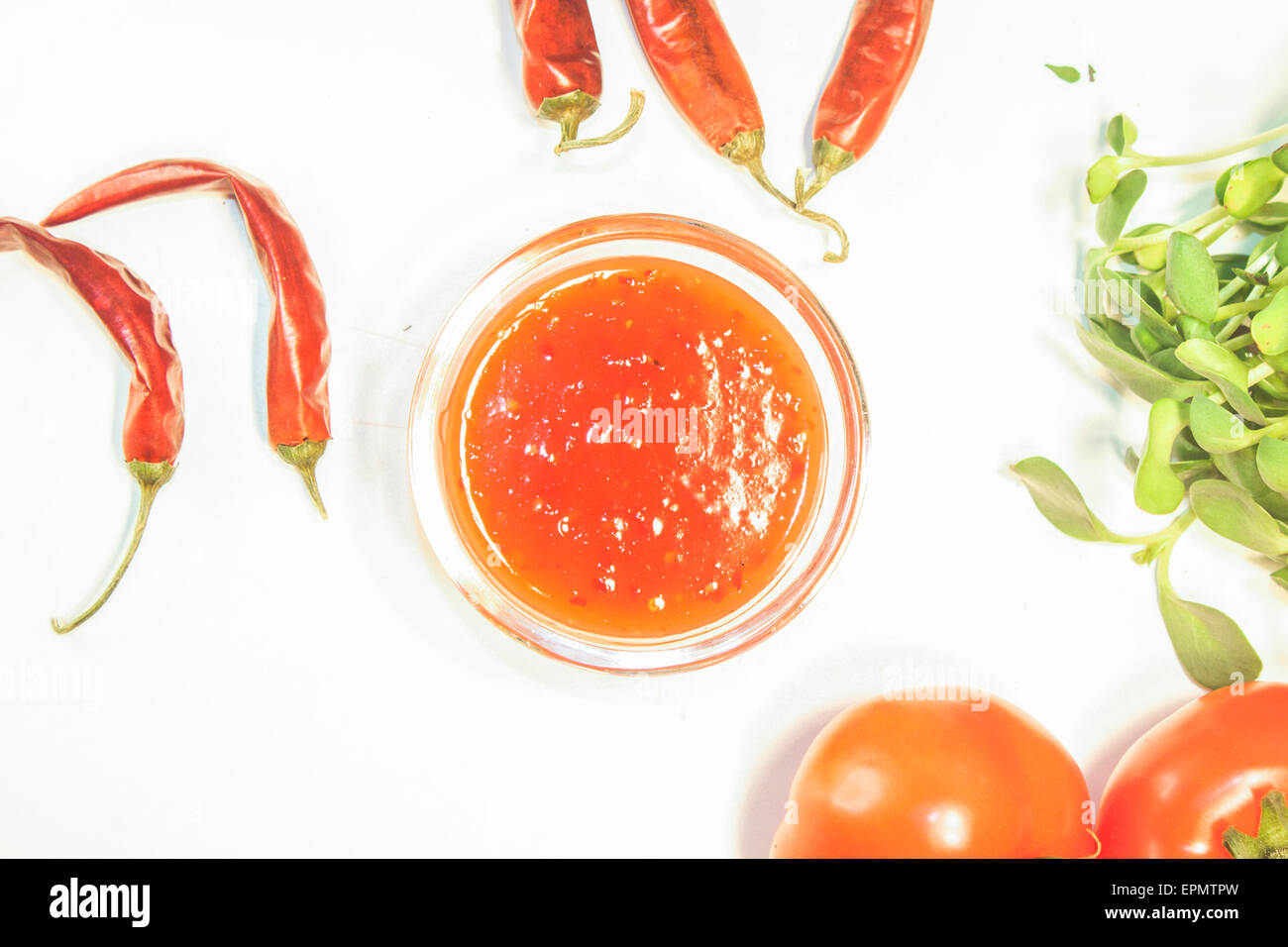 Sweet chili sauce, between chilis and herbs Stock Photo Alamy