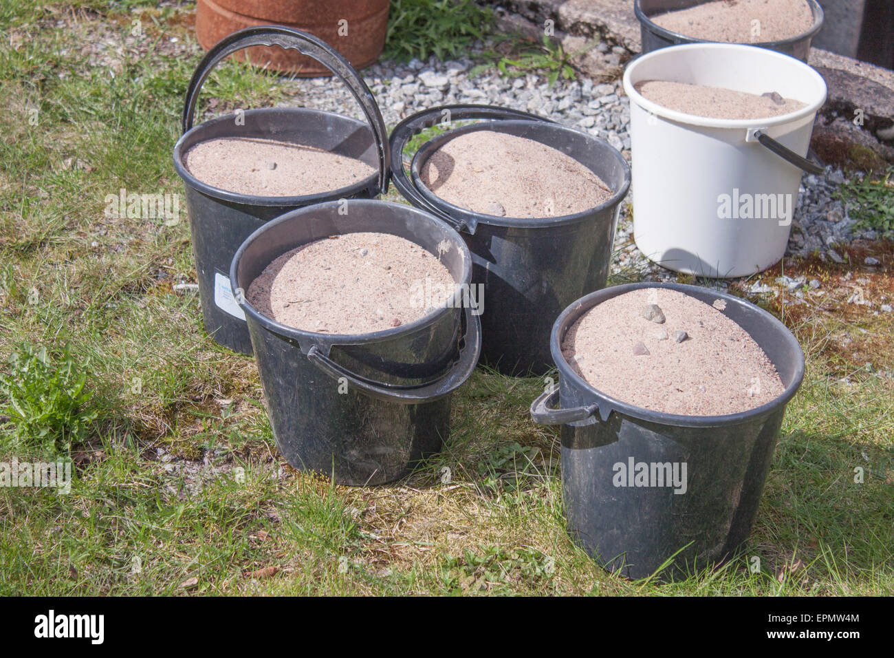 A lot of sand buckets, on a grass field Stock Photo