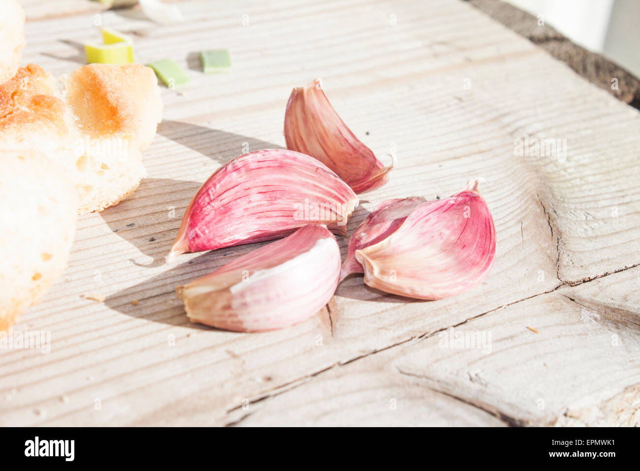 A lot of garlic cloves, on wooden background Stock Photo - Alamy