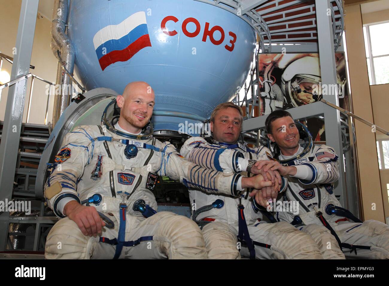 International Space Station Expedition 40 crew members ESA astronaut Alexander Gerst, left, Soyuz commander Max Suraev, center, and NASA astronaut Reid Wiseman pose in front of a Soyuz simulator at the Gagarin Cosmonaut Training Center May 6, 2015 in Star City, Russia. Stock Photo