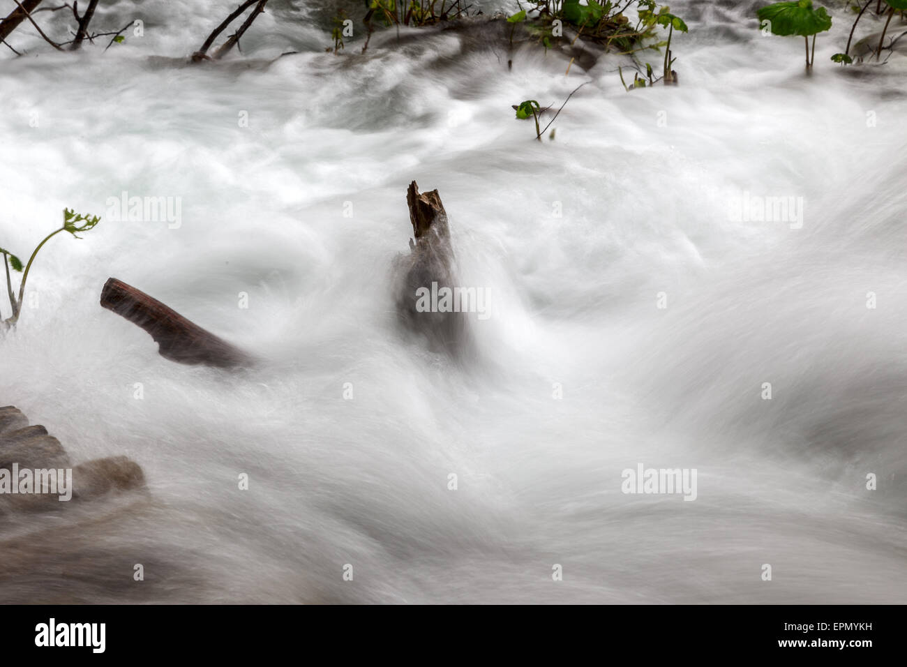 Closeup of Soft water cascading over mountain rocks.Soft Cascading water over mossy rocks Stock Photo