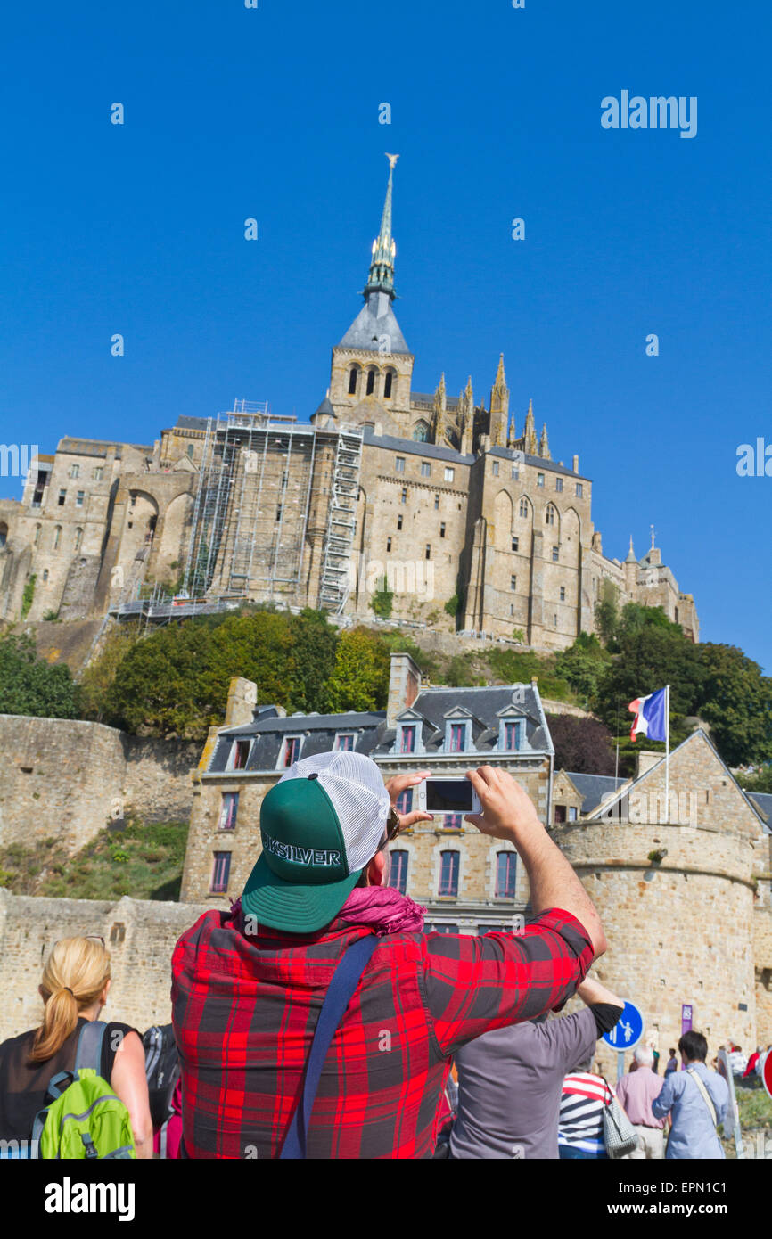 Tourist photographing Mont St Michel in Normandy Stock Photo
