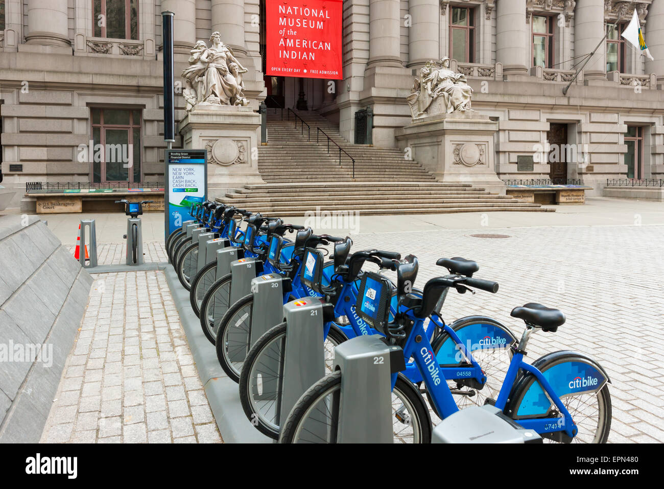 Citi Bike bicycles wait for riders at a docking station near the National Museum of the American Indian in New York City. Stock Photo