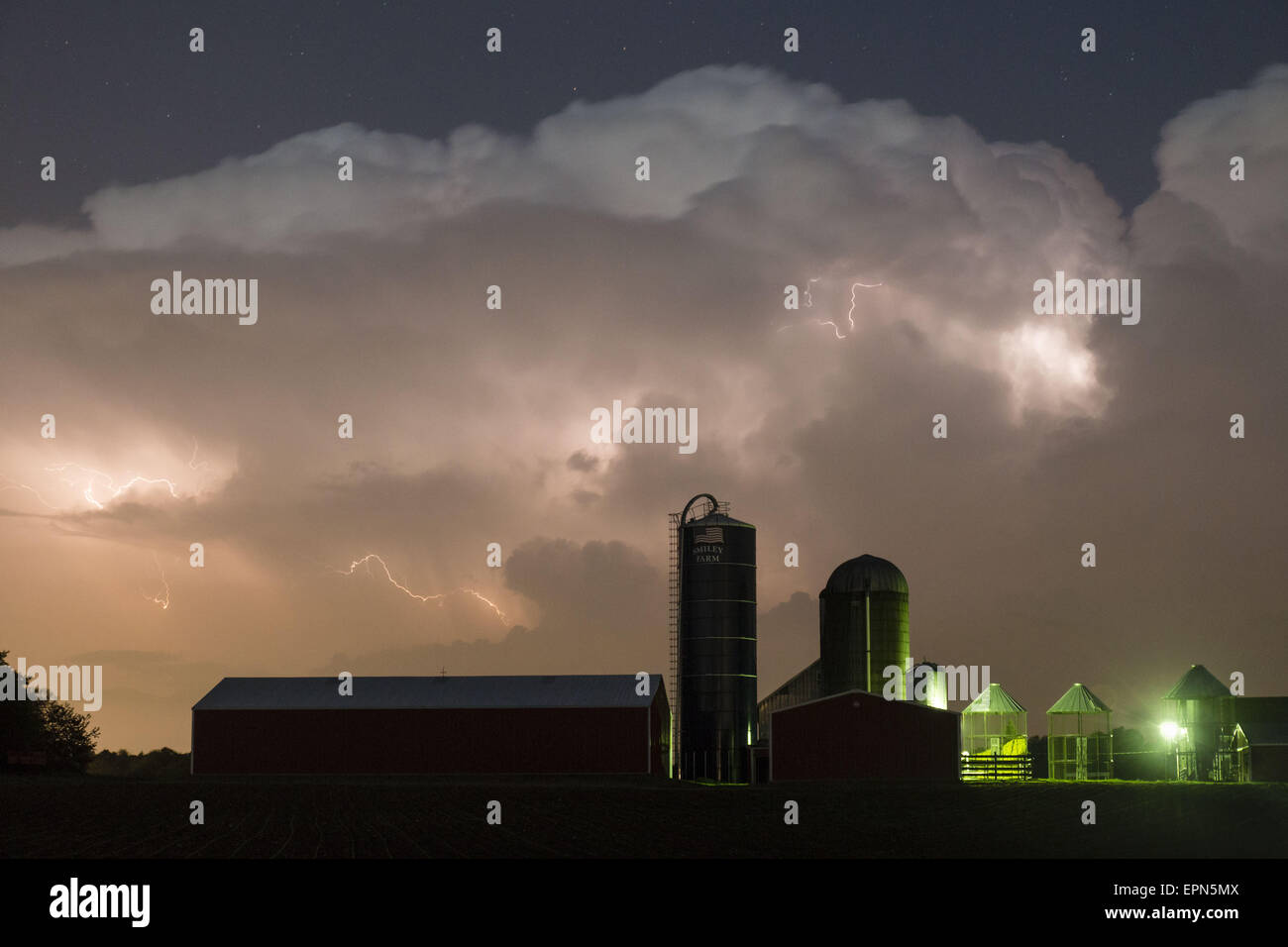 Town Of Wallkill, N.Y, USA. 19th May, 2015. Lightning flashes in the clouds above the barn and silos of a farm in the Town of Wallkill, New York, during a spring thunderstorm. © Tom Bushey/ZUMA Wire/Alamy Live News Stock Photo
