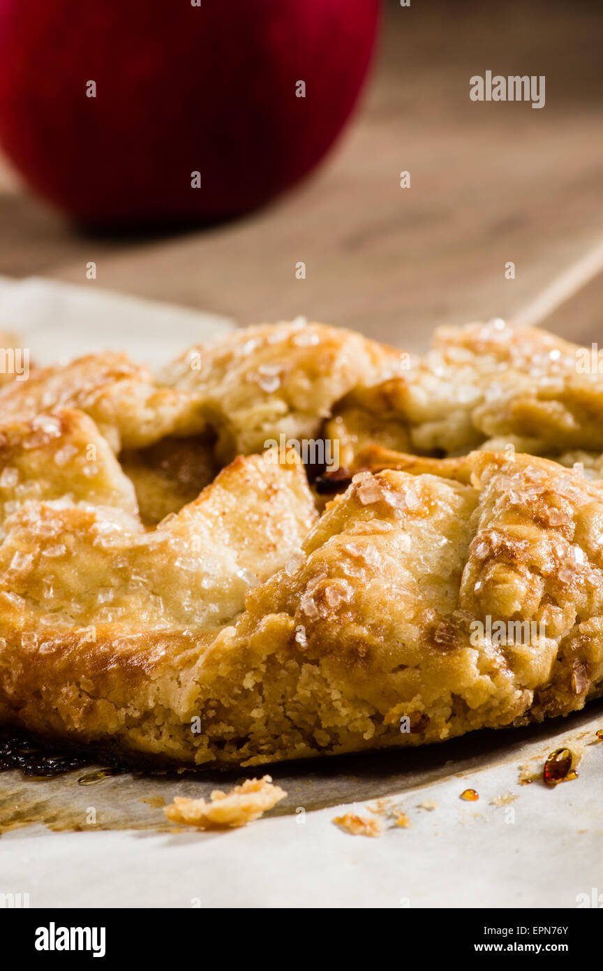 Apple tart with red apple on wooden table Stock Photo