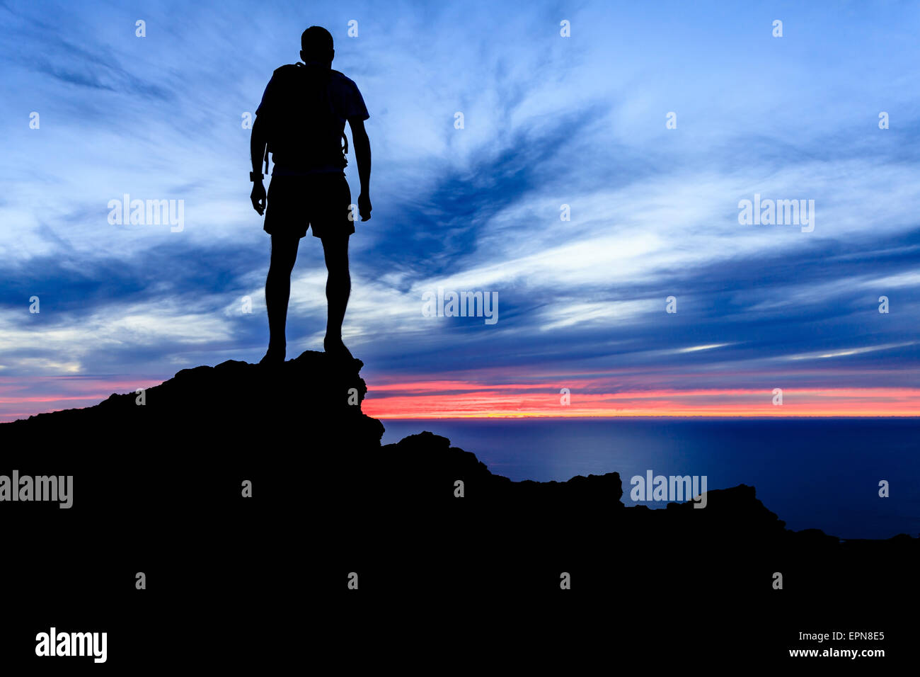 Man hiking silhouette in mountains, sunset and ocean over beautiful ...