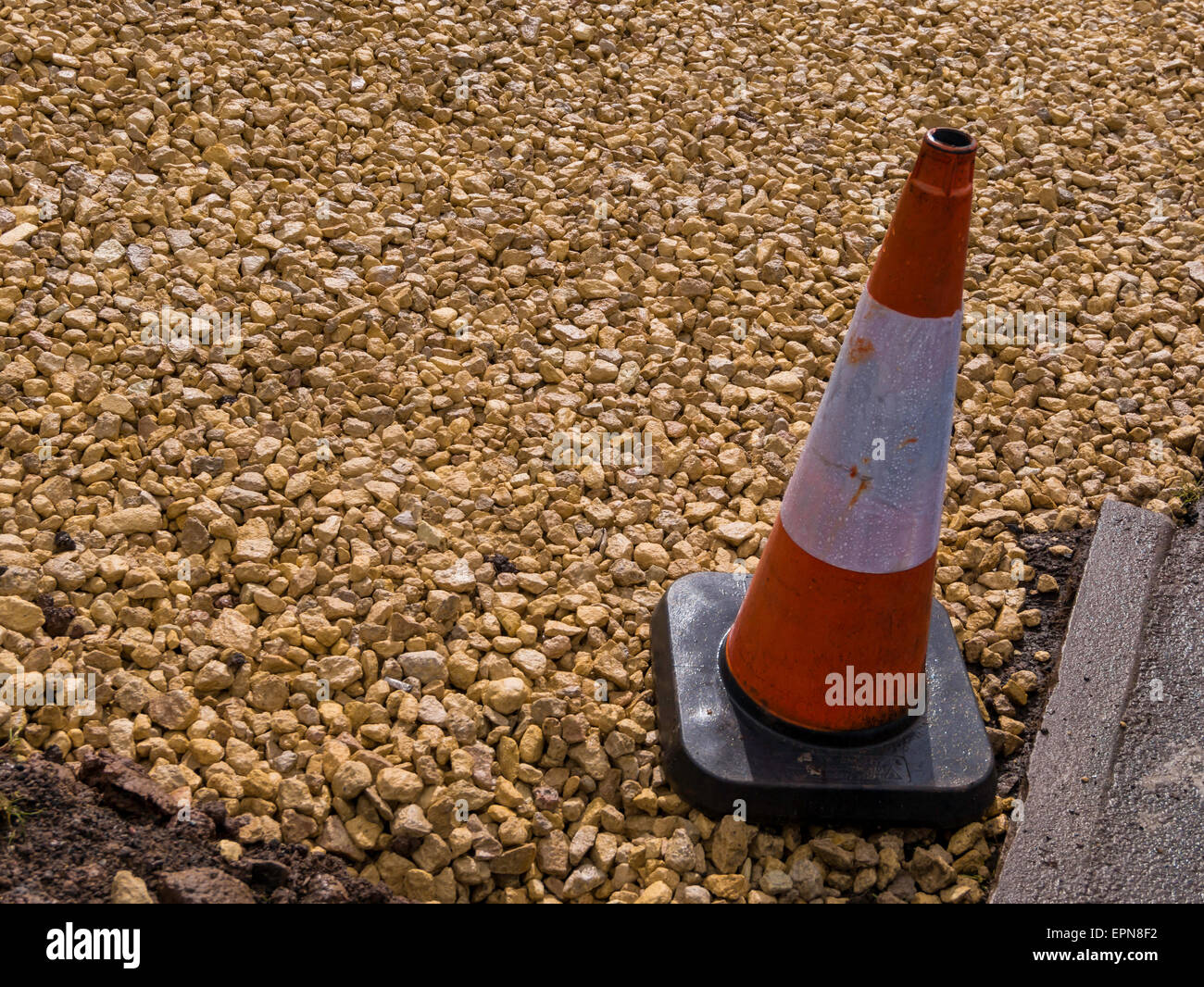 Crushed Dolomite rock laid to provide a sub-base for a paved driveway Stock Photo