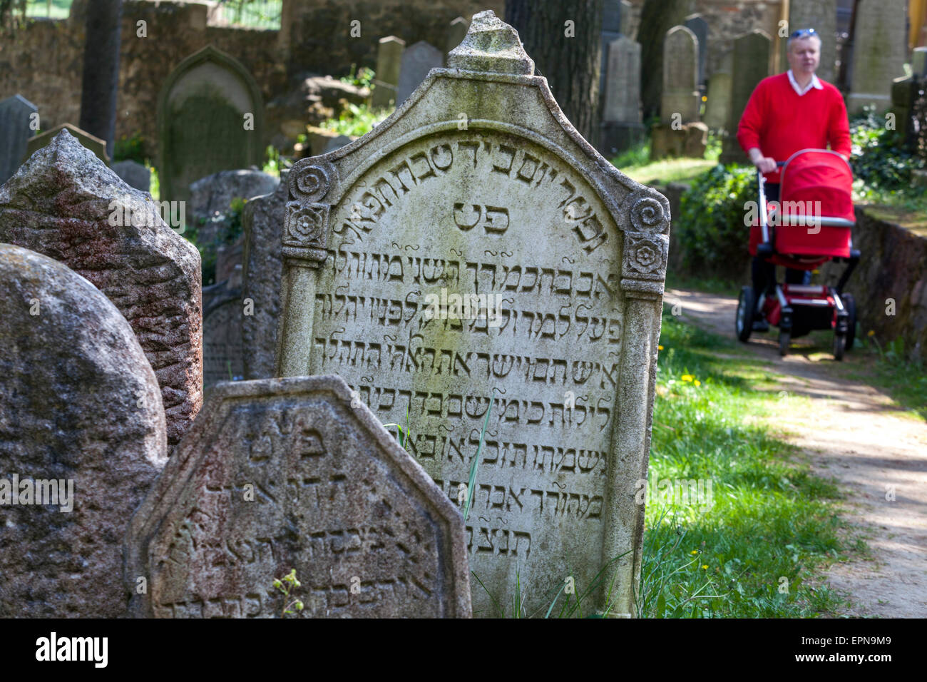 Trebic Czech Republic, Old Jewish cemetery, UNESCO World Heritage sites. A man walking with a baby stroller., Man pushing pram Stock Photo