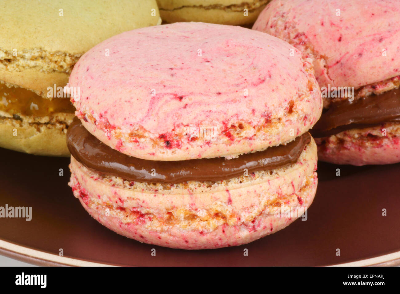 Assorted homemade macaroons with chocolate and jam filling. Macaroons are French sweets composed of two meringue added with almo Stock Photo
