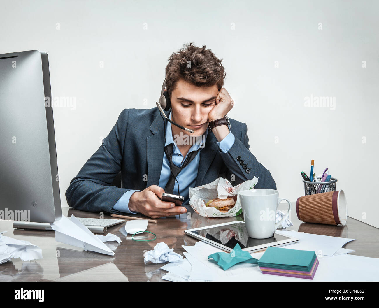 Trifle away one's time / modern office man at working place, sloth and laziness at work concept Stock Photo