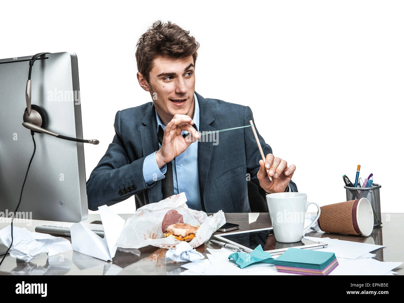 Сatapult slingshot / modern office man at working place, sloth and laziness concept Stock Photo