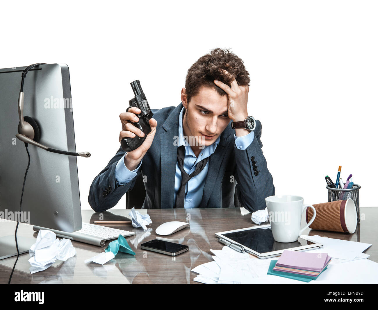 Young office man with gun wants to commit suicide / modern office man at working place, depression and crisis concept Stock Photo