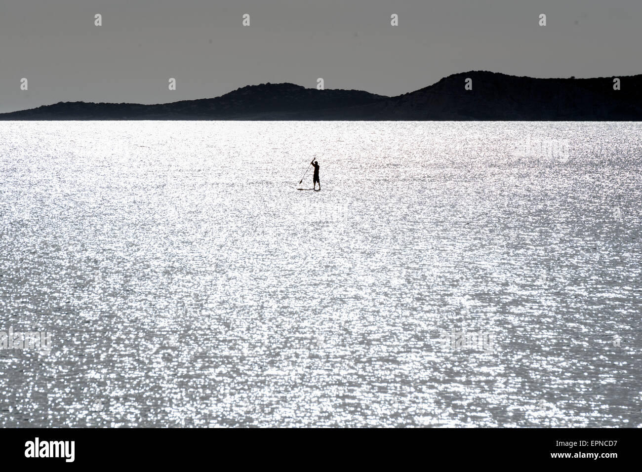 Silhouettes of Stand up paddle surfers (paddle boarders) at sunset. Ibiza coast Stock Photo