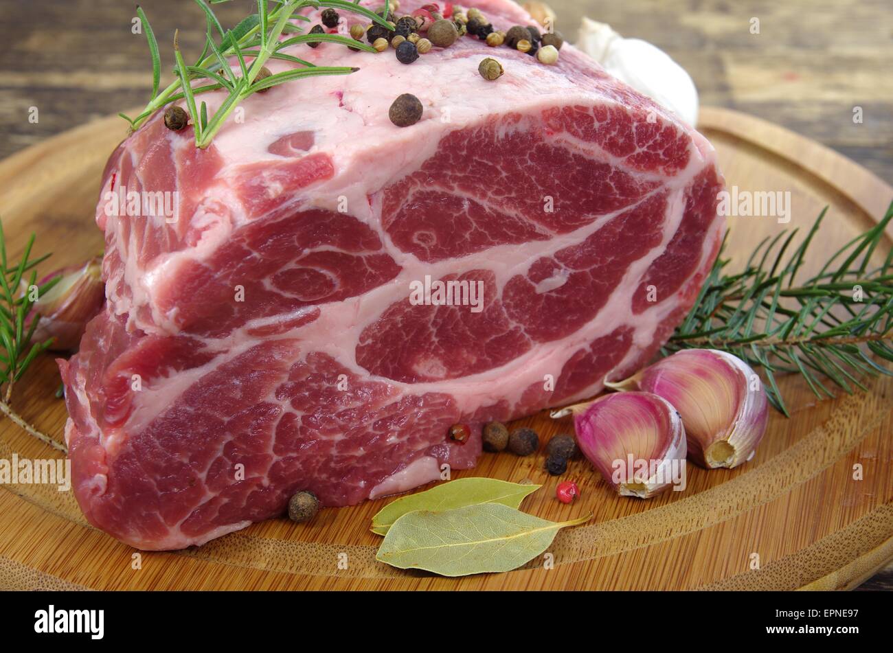 neck with rosemary and basil on chopping board Stock Photo