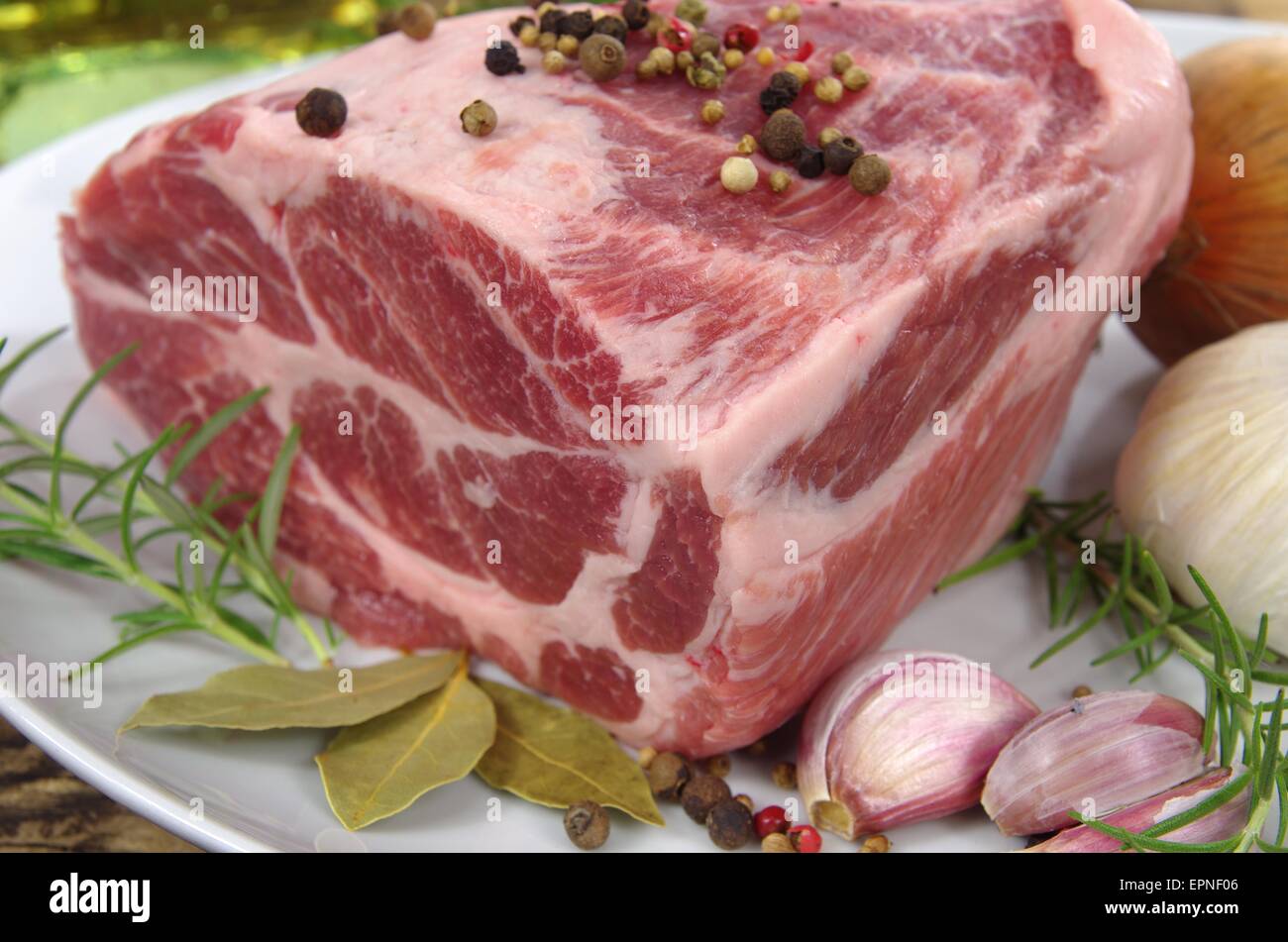 neck with rosemary and basil on white plate Stock Photo