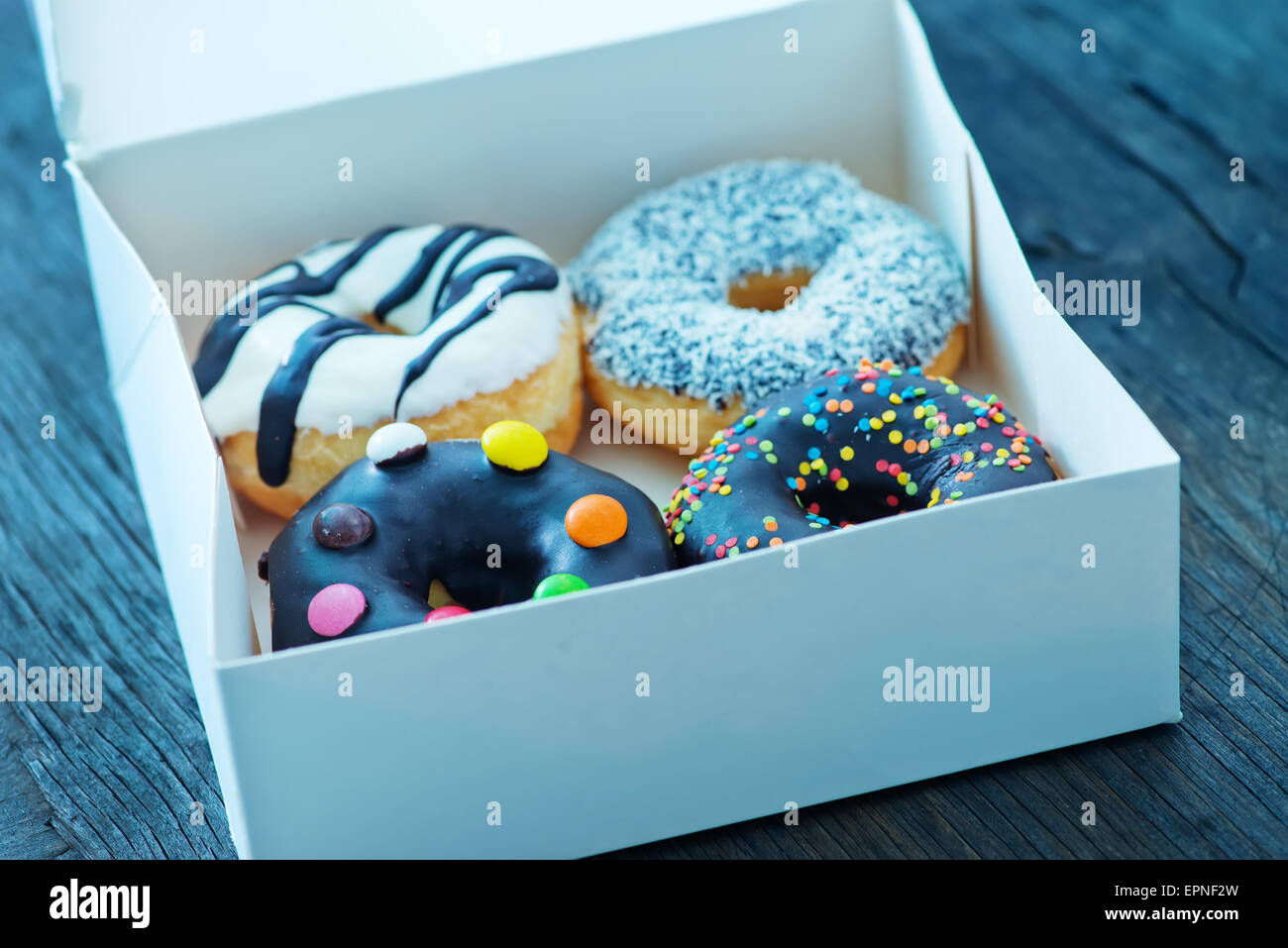 donuts in white box and on a table Stock Photo - Alamy