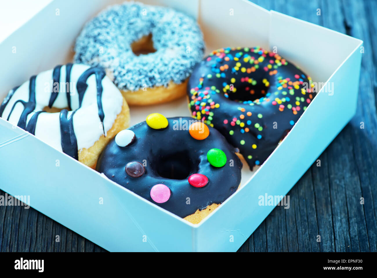 donuts in white box and on a table Stock Photo - Alamy