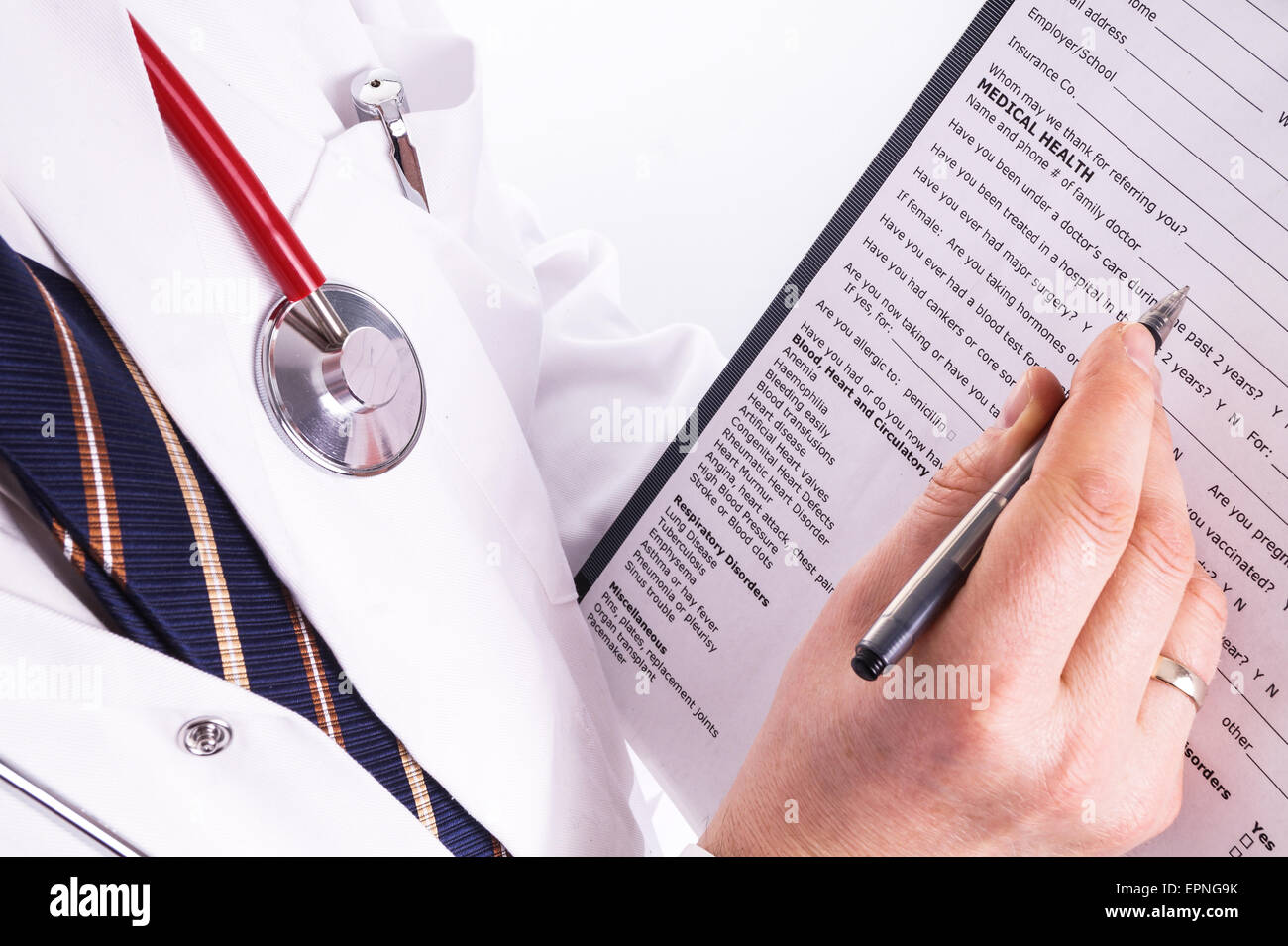 Male doctor fills patient registration form prior to admission and
