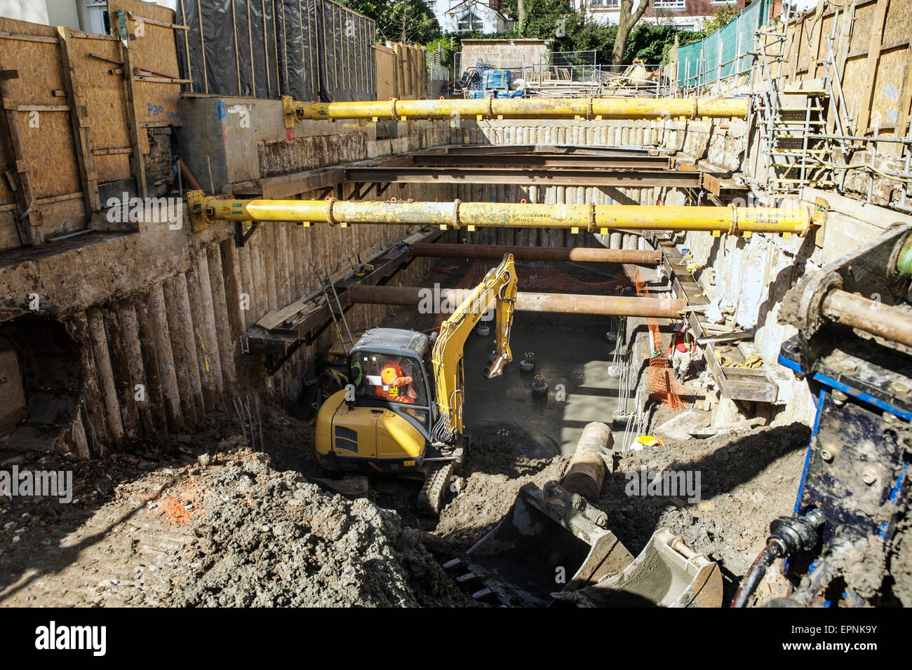 Property redevelopment building site: underground excavation, basement foundation work, hydraulic corner bracing struts. Stock Photo