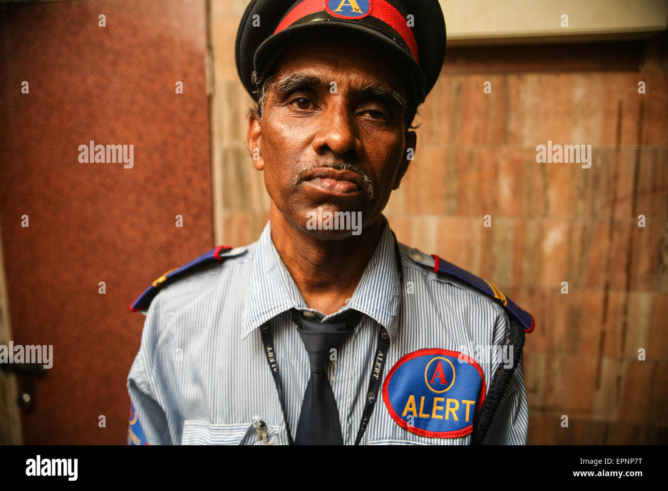 Elderly security guard at residential apartment building housing rich