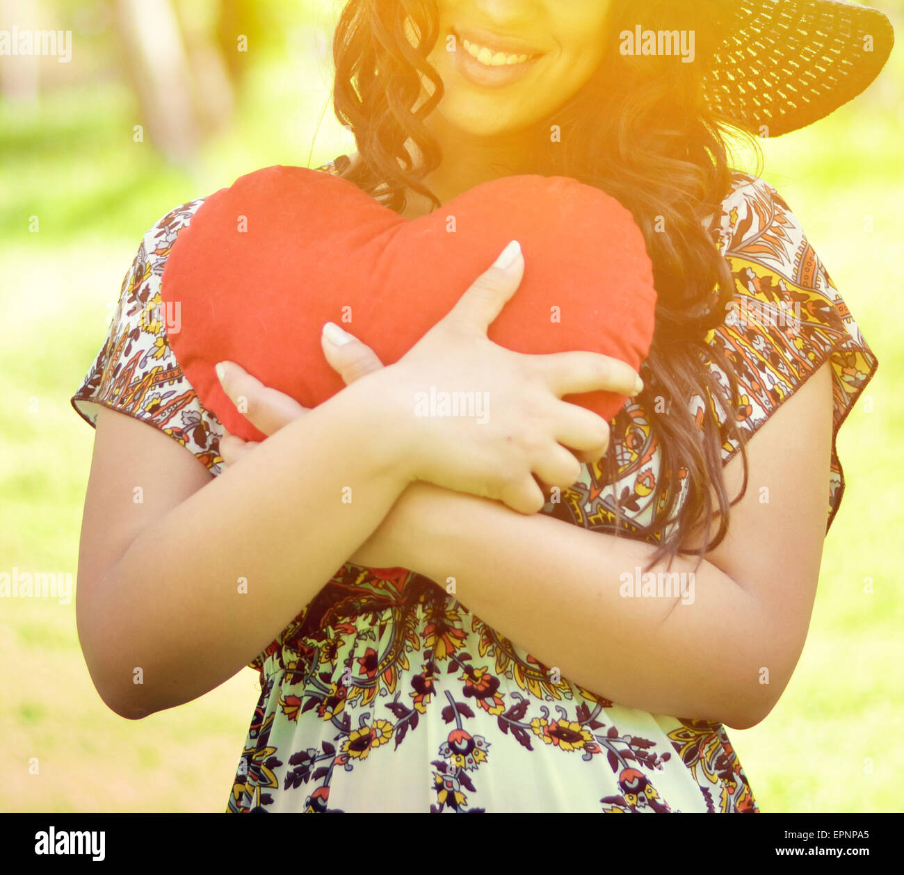 Portrait of beautiful girl holding big red heart Stock Photo - Alamy