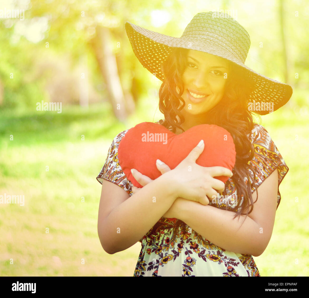 Portrait of beautiful girl holding big red heart Stock Photo - Alamy