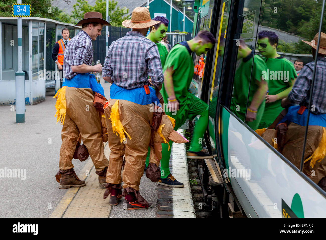 A Group Of Young Men Boarding An Early Morning Train, Lewes Station, Lewes, Sussex, UK Stock Photo