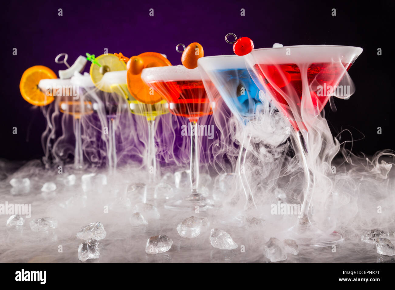 Martini drinks with dry ice smoke effect, served on bar counter with