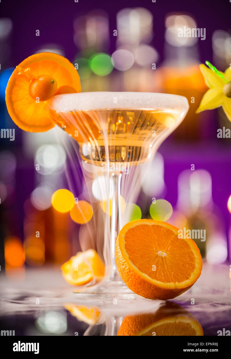 Martini drink with dry ice smoke effect, served on bar counter with