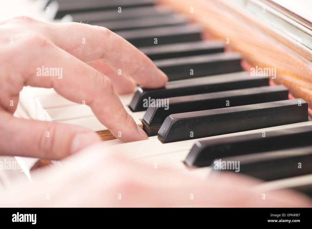 Close up of hands of man playing the piano Stock Photo