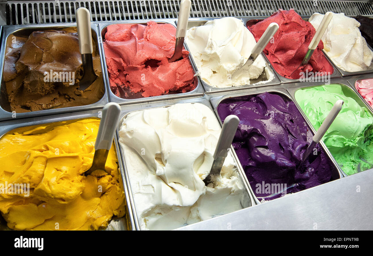 Colorful display of an assortment of freshly made different fruity flavored Italian ice cream in the window of an ice cream par Stock Photo