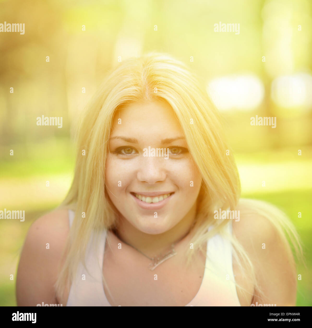 Portrait of happy girl with blonde hair outdoors Stock Photo - Alamy
