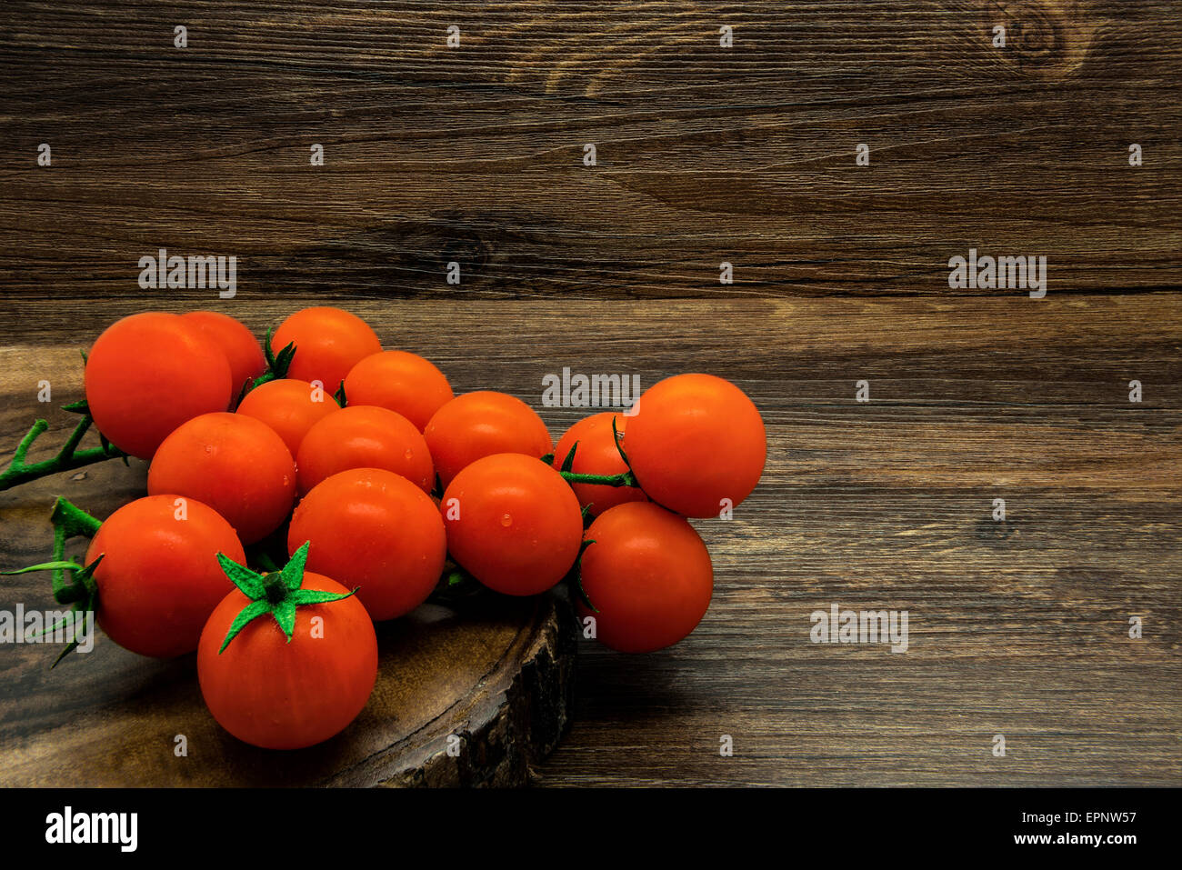 Cherry tomatoes on a wooden rustic background. Stock Photo