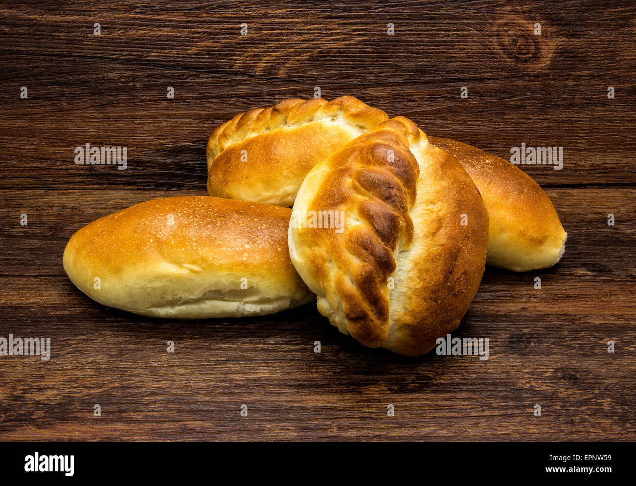 Crispy white buns on a wooden rustic background. Stock Photo