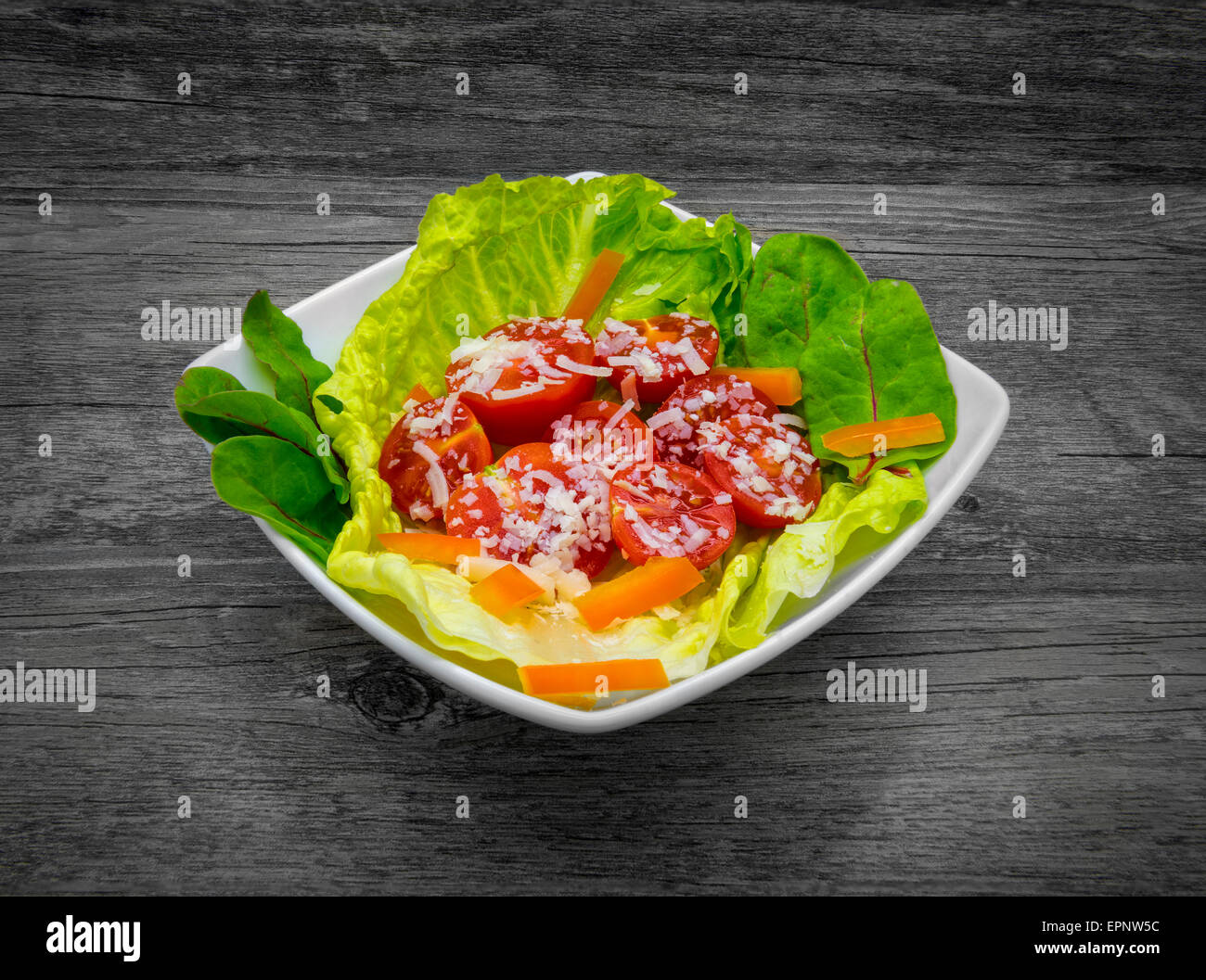 Fresh salad on a rustic wooden background. Stock Photo