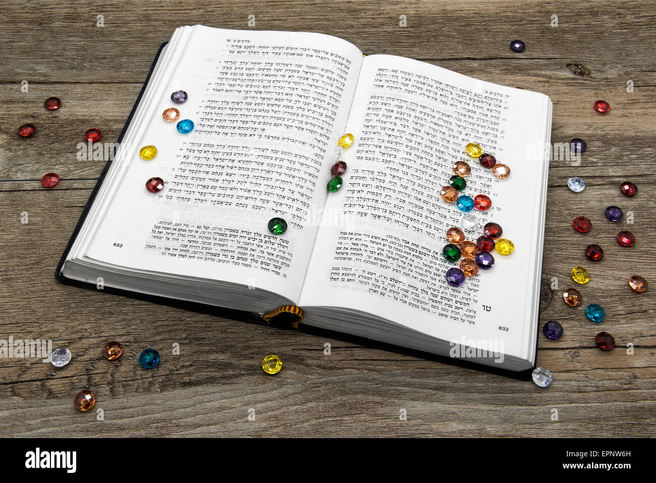 Torah book with precious stones on a wooden background. Stock Photo