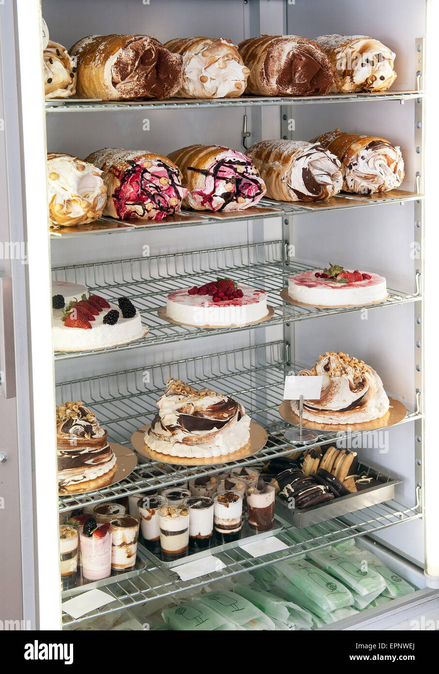Display of traditional Italian semifreddo cakes and desserts in a refrigerator made from semi frozen ice cream and cream whipped Stock Photo