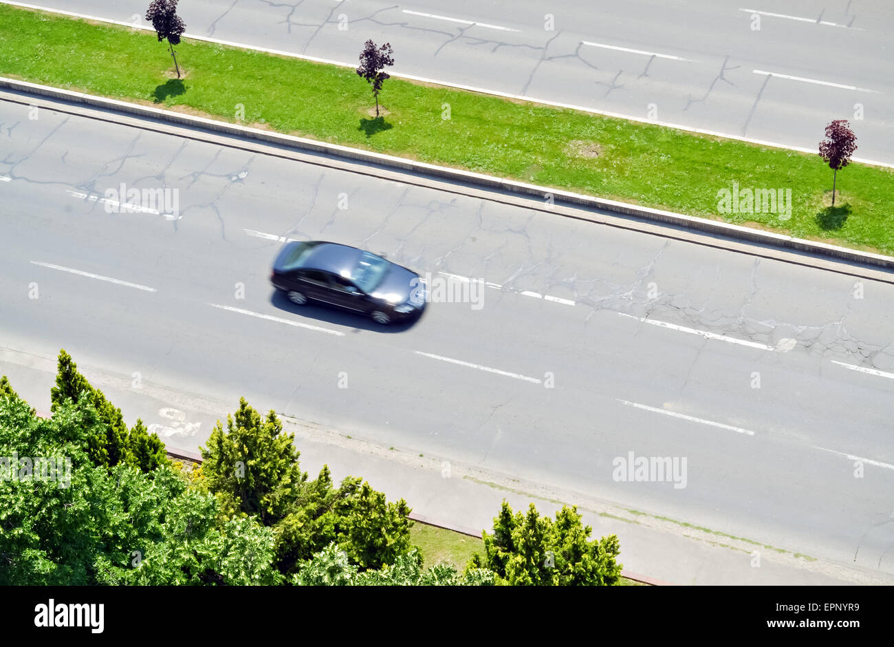 Blurred black car in motion on the city boulevard Stock Photo