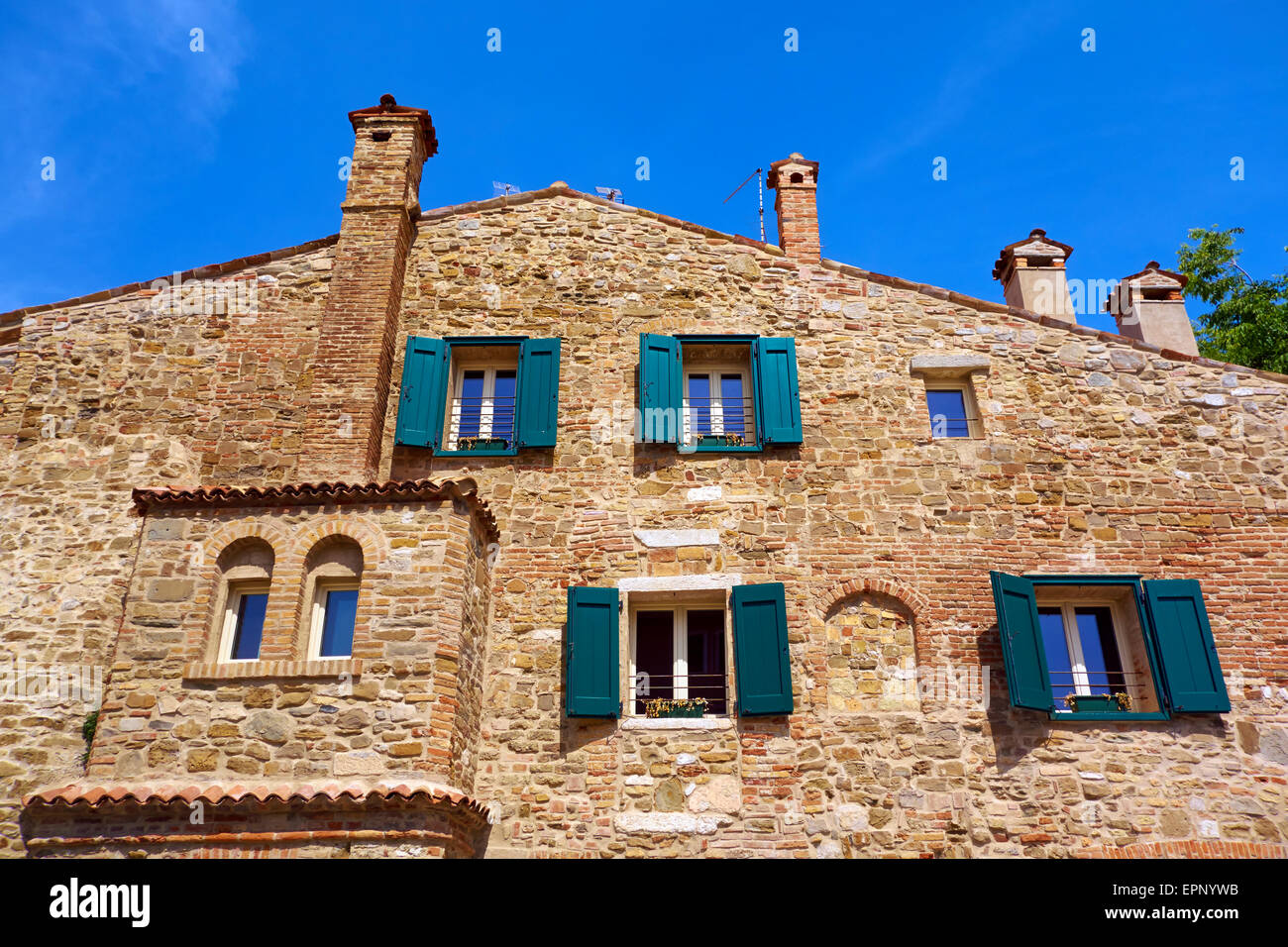 Old House Facade With Windows and Chimneys in Grado, Friuli - Venezia Giulia, Italy, Adriatic Sea. Stock Photo