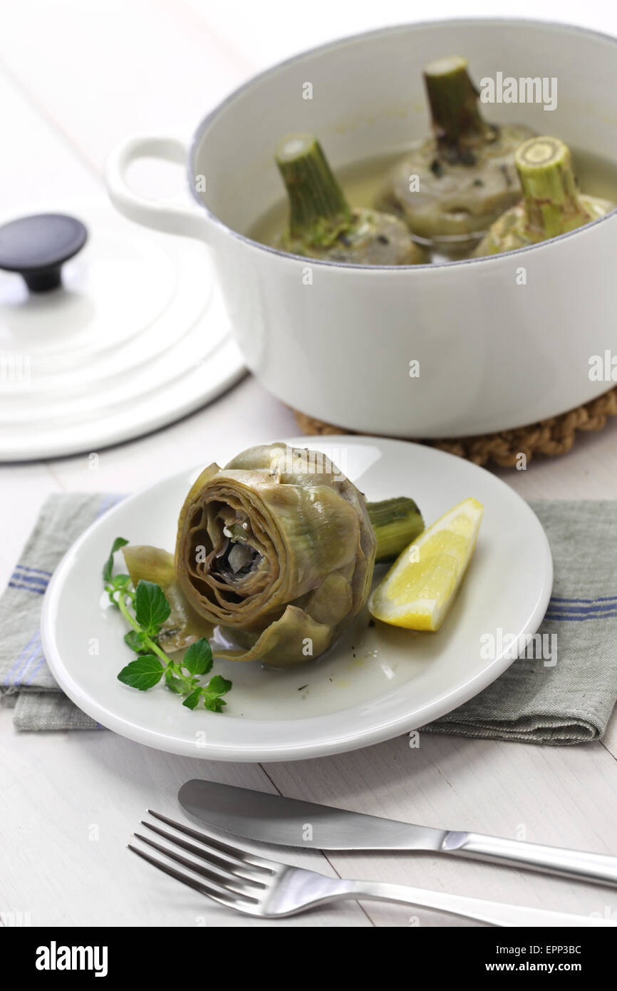 eating boiled artichoke, italian cuisine Stock Photo
