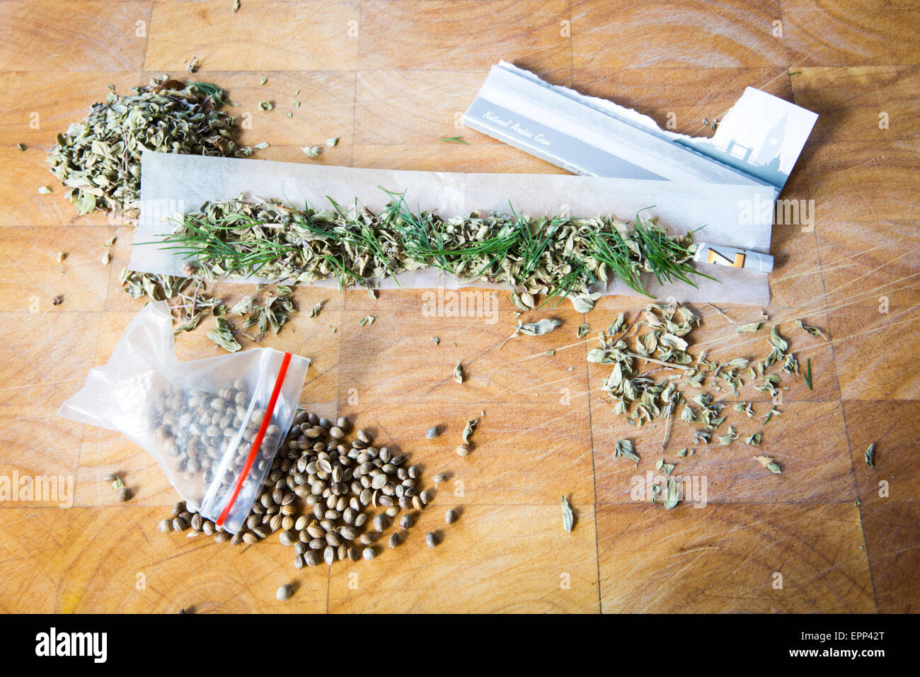 Humorous depiction of a hemp inspired meal featuring hemp seeds, oregano, dill, rizlas. Stock Photo