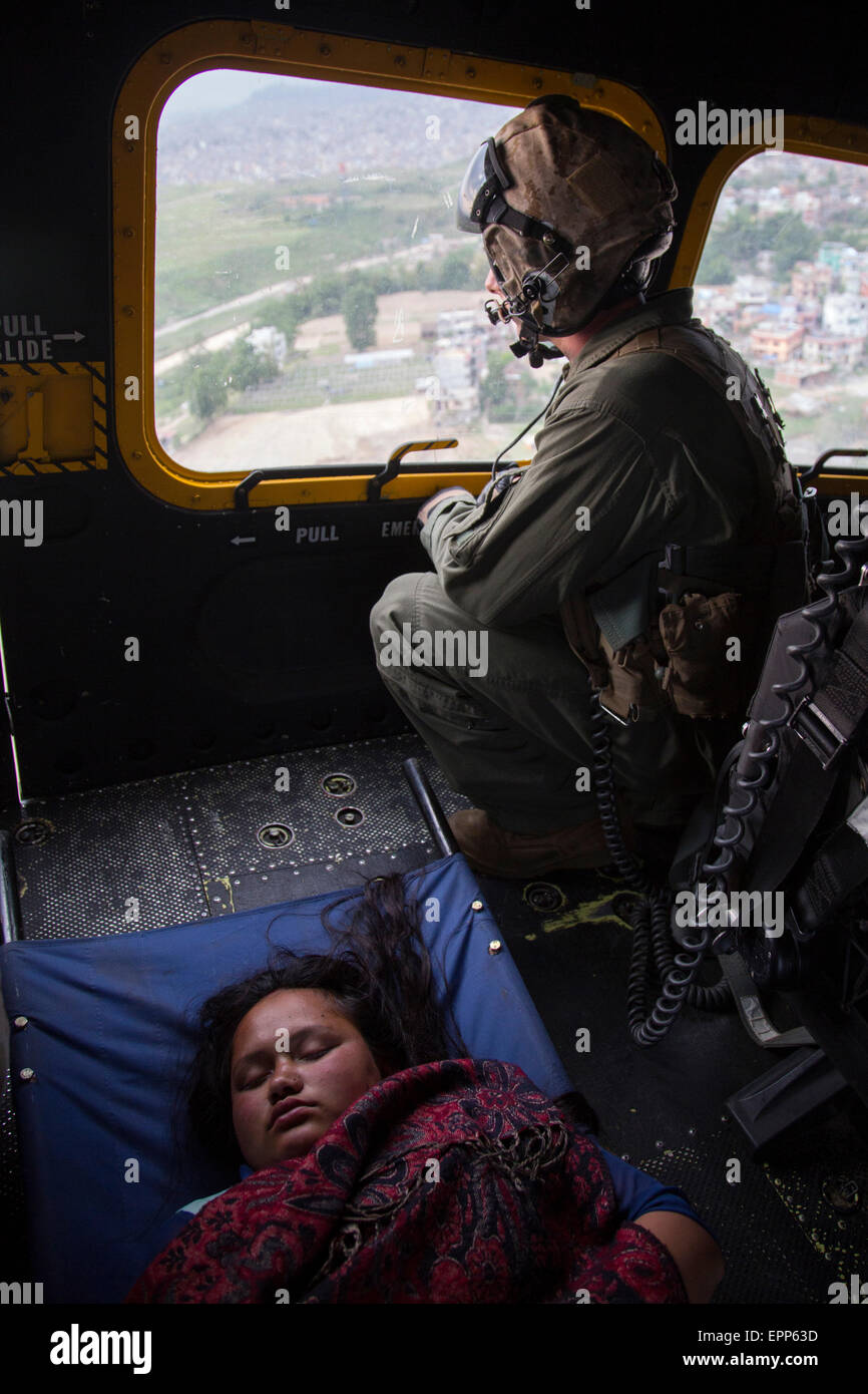 An injured Nepali earthquake victim is transported in a U.S. Marine Corps UH-1Y Venom helicopter to the hospital May 19, 2015 in Kathmandu, Nepal. Nepal is recovering from a 7.8 magnitude earthquake that struck the kingdom, April 25 and a 7.3 earthquake on May 12. Stock Photo