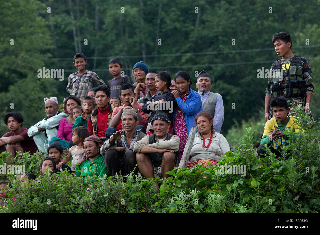 Nepalese villagers watch as Relief supplies are unloaded from a U.S. Marine Corps UH-1Y Venom helicopter in a remote area May 19, 2015 in Nepal. Nepal is recovering from a 7.8 magnitude earthquake that struck the kingdom, April 25 and a 7.3 earthquake on May 12. Stock Photo
