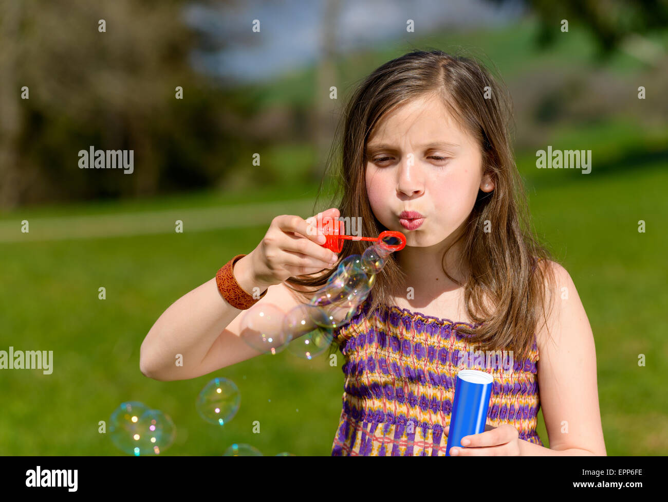 a little girl making soap bubbles in nature Stock Photo - Alamy