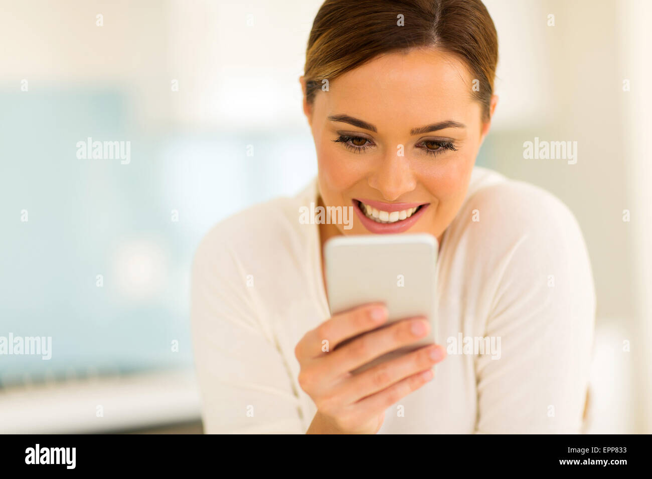 attractive woman texting on her cell phone Stock Photo - Alamy