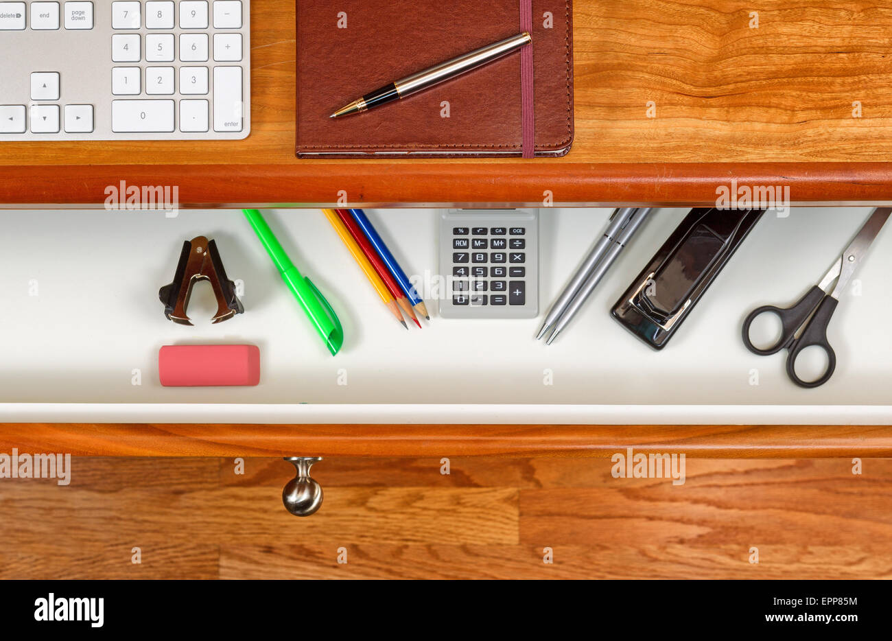 High Angle Shot Of Open Desk Drawer With Work Items Inside Red