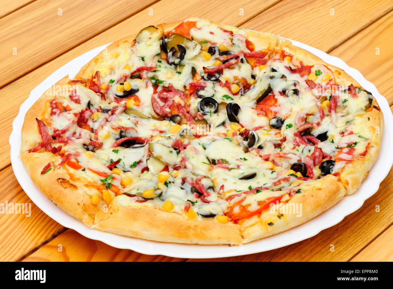 Pizza with pepperoni, black olives and corn Stock Photo Alamy